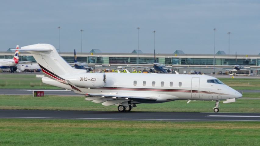 A white Bombardier Challenger 350 on the runway.