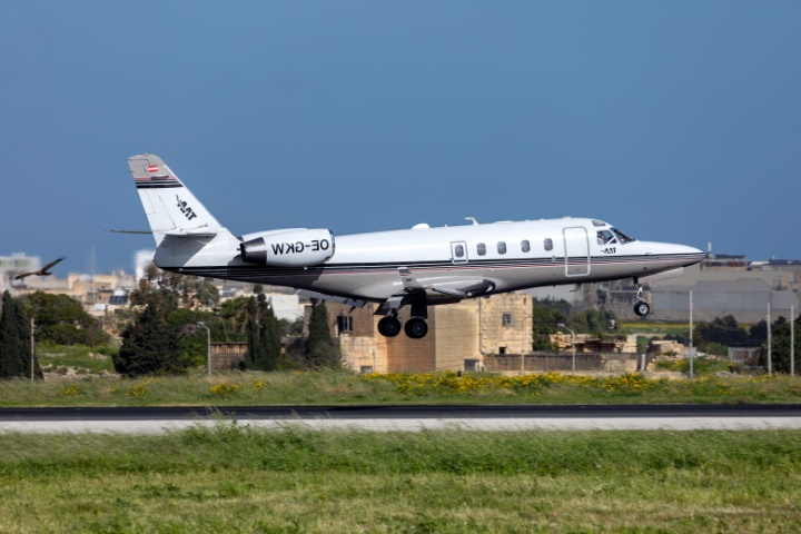 A white Gulfstream G100 taking off