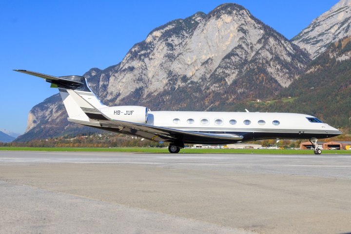 A parked Gulfstream G650. In the background you can see mountains